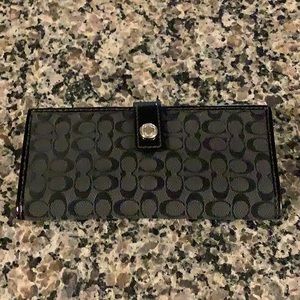 Coach sig C’s black wallet.